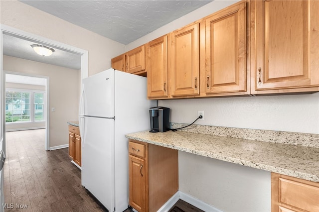 907 Hillsdale Ave, Parma, OH 44134 - kitchen featuring freestanding refrigerator, dark wood-style flooring, and light stone countertops