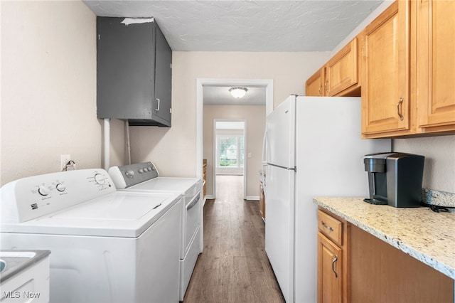 907 Hillsdale Ave, Parma, OH 44134 - washroom with washing machine and clothes dryer, light wood-type flooring, cabinet space, and a textured ceiling