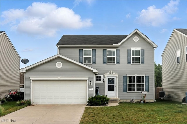 3990 Abigail Dr, Lorain, OH 44053 - colonial-style house featuring driveway, a front yard, and an attached garage