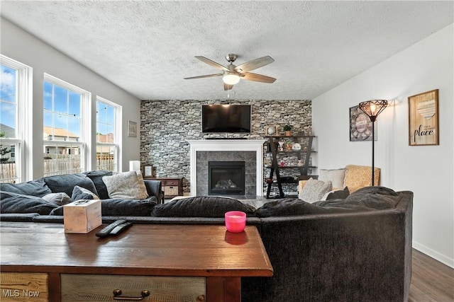 3990 Abigail Dr, Lorain, OH 44053 - living area with a ceiling fan, wood finished floors, a fireplace, and a textured ceiling