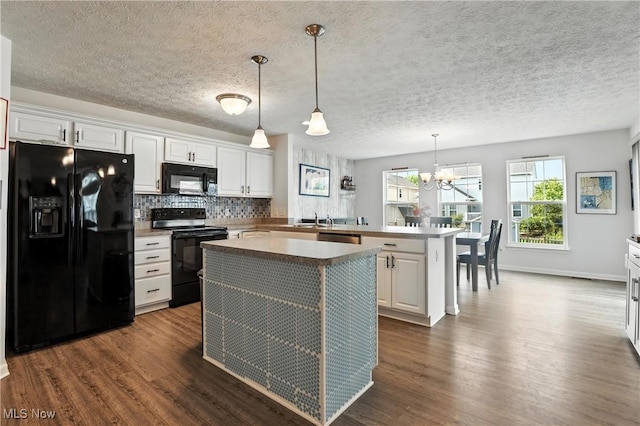 3990 Abigail Dr, Lorain, OH 44053 - kitchen featuring black appliances, a peninsula, dark wood-type flooring, white cabinets, and a textured ceiling