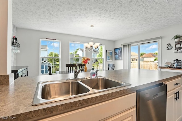 3990 Abigail Dr, Lorain, OH 44053 - kitchen featuring dishwasher, a chandelier, decorative light fixtures, a textured ceiling, and dark countertops