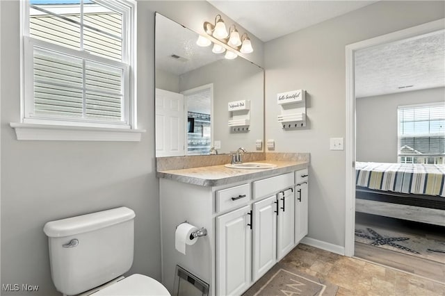 3990 Abigail Dr, Lorain, OH 44053 - bathroom featuring vanity, ensuite bath, and stone finish flooring