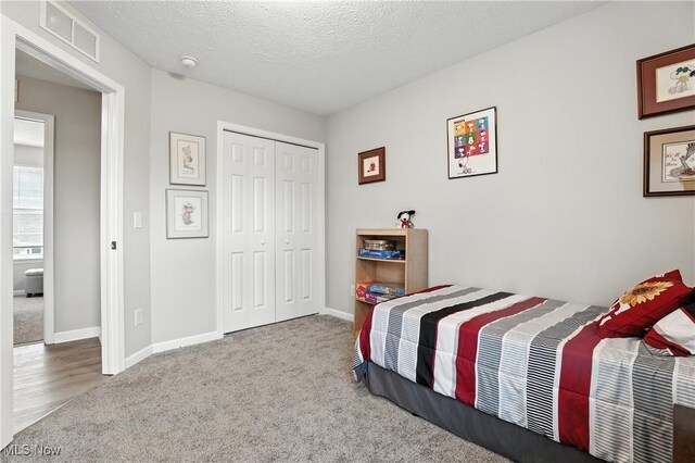 3990 Abigail Dr, Lorain, OH 44053 - carpeted bedroom with a closet and a textured ceiling