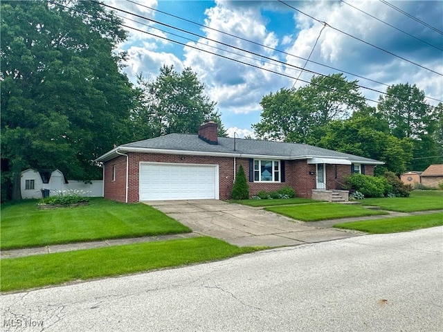 344 17th St NW, Barberton, OH 44203 - ranch-style home with a garage, brick siding, driveway, a chimney, and a front lawn