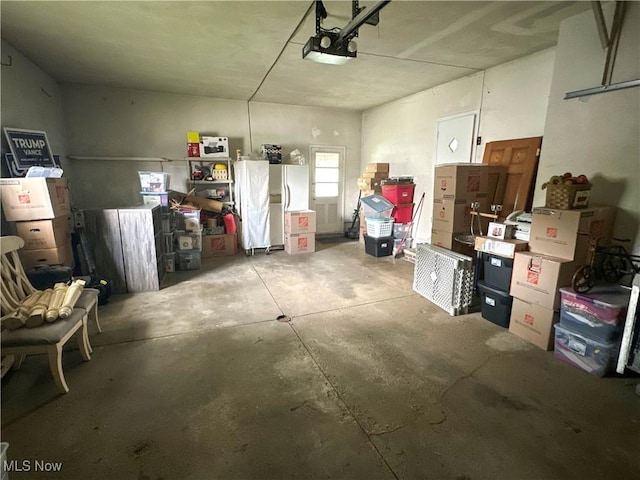344 17th St NW, Barberton, OH 44203 - garage with a garage door opener and freestanding refrigerator