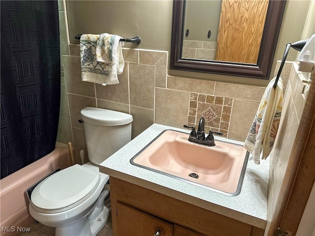 344 17th St NW, Barberton, OH 44203 - full bathroom featuring vanity, shower / bath combination with curtain, decorative backsplash, and tile walls