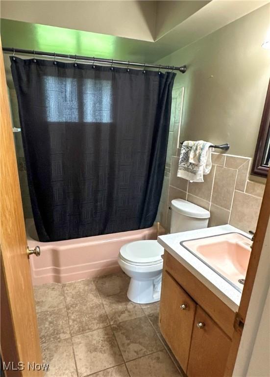 344 17th St NW, Barberton, OH 44203 - full bath with vanity, shower / bath combo with shower curtain, and tile walls