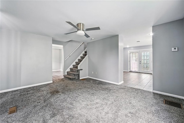 356 Warren Ave, Niles, OH 44446 - unfurnished living room featuring carpet flooring, french doors, a ceiling fan, and stairs