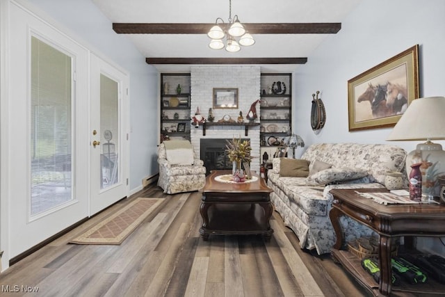 1114 Beechwood Rd, Salem, OH 44460 - living area featuring wood finished floors, a chandelier, beam ceiling, a brick fireplace, and french doors