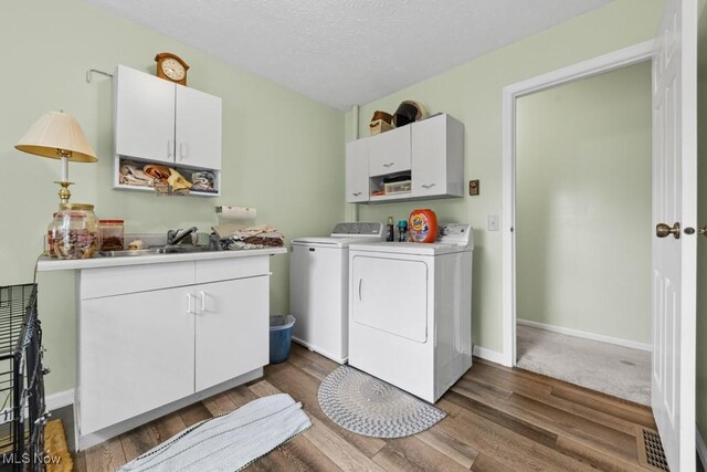 1114 Beechwood Rd, Salem, OH 44460 - laundry area featuring cabinet space, washer and dryer, wood finished floors, and a textured ceiling