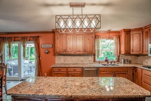 3020 Crookston Ln, Clinton, OH 44216 - kitchen with appliances with stainless steel finishes, a center island, plenty of natural light, tasteful backsplash, and ornamental molding