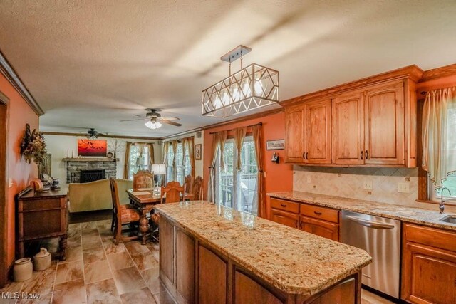 3020 Crookston Ln, Clinton, OH 44216 - kitchen featuring dishwasher, a kitchen island, brown cabinets, crown molding, and a textured ceiling
