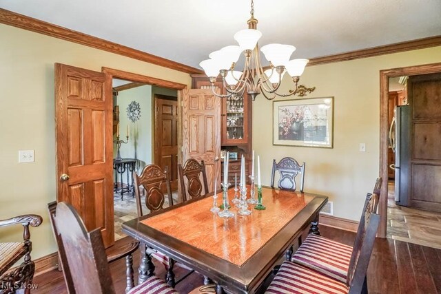 3020 Crookston Ln, Clinton, OH 44216 - dining room with a chandelier, ornamental molding, and wood finished floors
