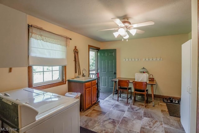 3020 Crookston Ln, Clinton, OH 44216 - laundry room with cabinet space, a ceiling fan, stone finish flooring, and independent washer and dryer