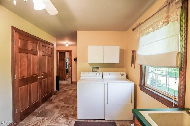 3020 Crookston Ln, Clinton, OH 44216 - laundry area featuring cabinet space, separate washer and dryer, stone finish floors, and ceiling fan