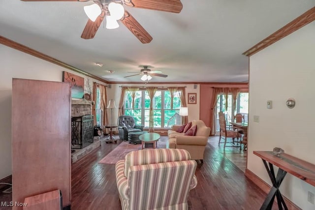 3020 Crookston Ln, Clinton, OH 44216 - living area with crown molding, a ceiling fan, hardwood / wood-style floors, and a stone fireplace