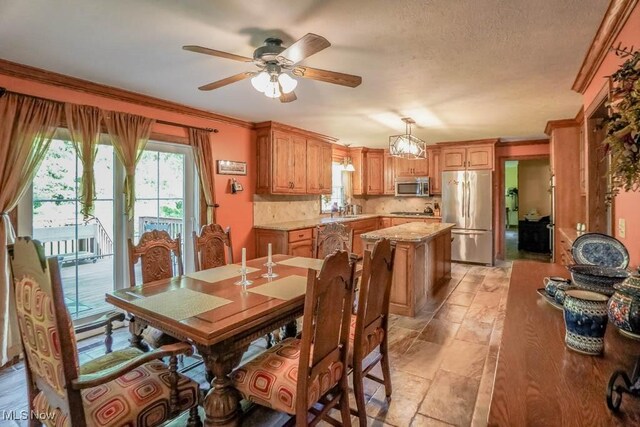 3020 Crookston Ln, Clinton, OH 44216 - dining space featuring a ceiling fan and crown molding
