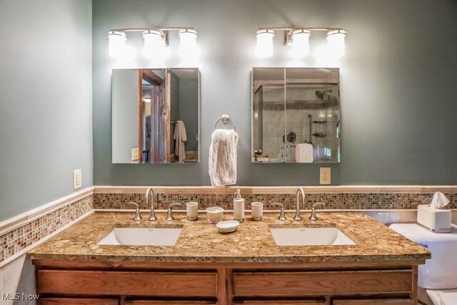 3020 Crookston Ln, Clinton, OH 44216 - full bath featuring double vanity, a shower stall, and a wainscoted wall