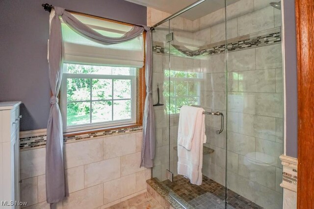 3020 Crookston Ln, Clinton, OH 44216 - bathroom featuring a stall shower and tile walls