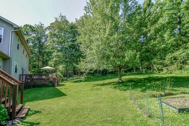 3020 Crookston Ln, Clinton, OH 44216 - view of grassy yard with a deck and view of scattered trees