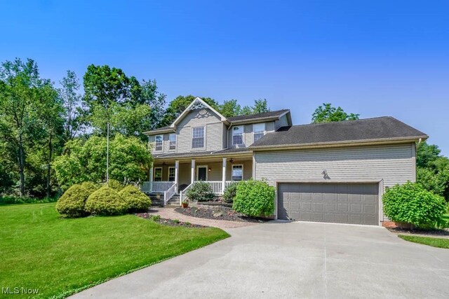 3020 Crookston Ln, Clinton, OH 44216 - view of front facade with a porch, a front lawn, a garage, and driveway