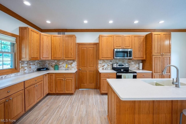 116 Falling Waters Dr, Vienna, WV 26105 - kitchen with stainless steel appliances, light countertops, light wood-style floors, decorative backsplash, and brown cabinets