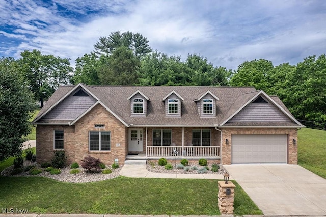 116 Falling Waters Dr, Vienna, WV 26105 - view of front of house with brick siding, covered porch, an attached garage, concrete driveway, and a front yard