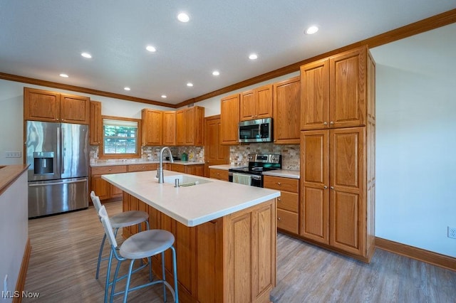116 Falling Waters Dr, Vienna, WV 26105 - kitchen with stainless steel appliances, decorative backsplash, light countertops, light wood-type flooring, and crown molding