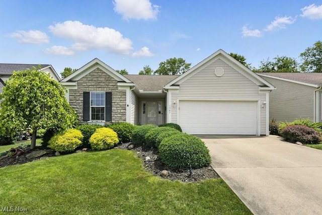 1367 Hidden Lake Blvd, Akron, OH 44312 - view of front of house with stone siding, a garage, driveway, and a front yard