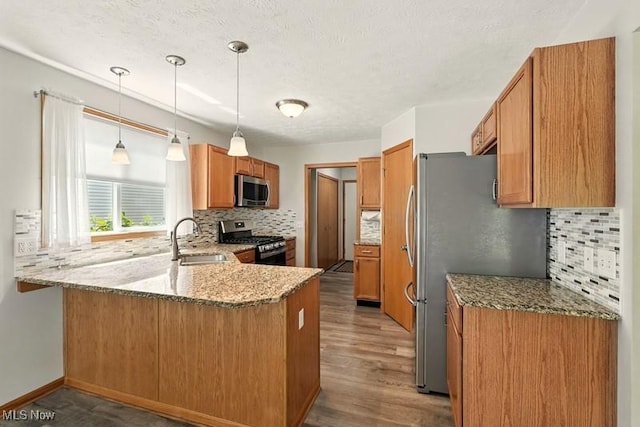 1367 Hidden Lake Blvd, Akron, OH 44312 - kitchen with stainless steel appliances, a peninsula, tasteful backsplash, light stone countertops, and a textured ceiling