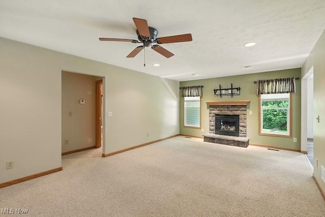 1367 Hidden Lake Blvd, Akron, OH 44312 - unfurnished living room featuring carpet floors, ceiling fan, a stone fireplace, and recessed lighting
