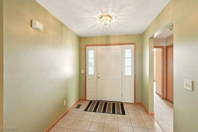 1367 Hidden Lake Blvd, Akron, OH 44312 - foyer entrance featuring light tile patterned flooring and a textured ceiling