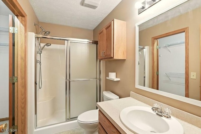 1367 Hidden Lake Blvd, Akron, OH 44312 - bathroom with a shower stall, vanity, a textured ceiling, and a walk in closet