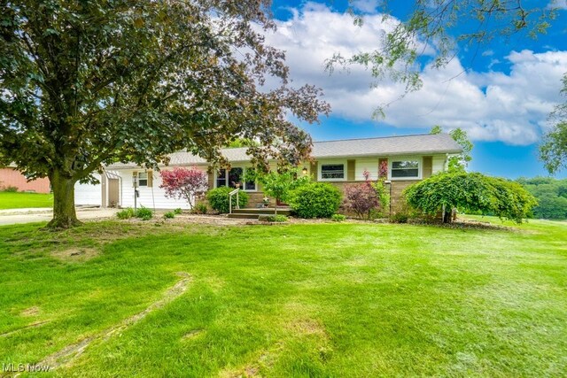 1260 Pleasant Ridge St SE, Minerva, OH 44657 - view of front of house with a garage, a front lawn, and driveway