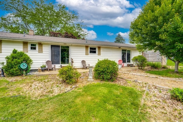 1260 Pleasant Ridge St SE, Minerva, OH 44657 - back of property with a patio area, a chimney, and a lawn