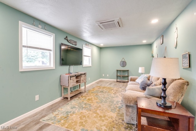 1260 Pleasant Ridge St SE, Minerva, OH 44657 - living room featuring wood finished floors, recessed lighting, and a textured ceiling