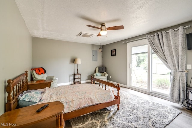 1260 Pleasant Ridge St SE, Minerva, OH 44657 - bedroom featuring a textured ceiling, access to exterior, electric panel, wood finished floors, and ceiling fan