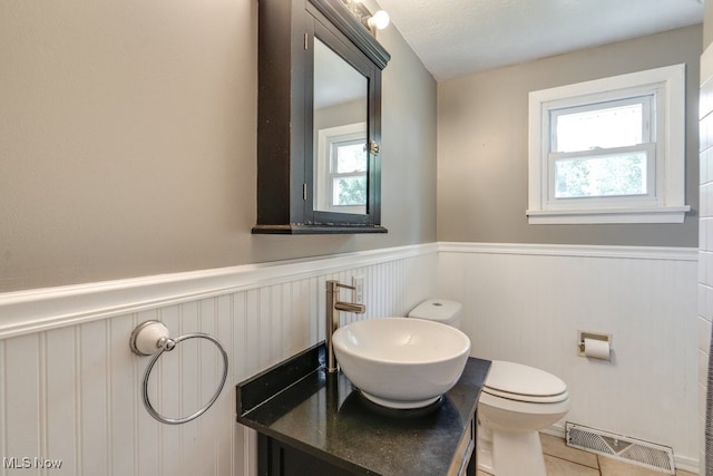 1260 Pleasant Ridge St SE, Minerva, OH 44657 - bathroom featuring a wainscoted wall, healthy amount of natural light, vanity, and tile patterned floors