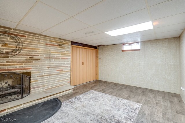 1260 Pleasant Ridge St SE, Minerva, OH 44657 - basement with a paneled ceiling, wood finished floors, and a fireplace
