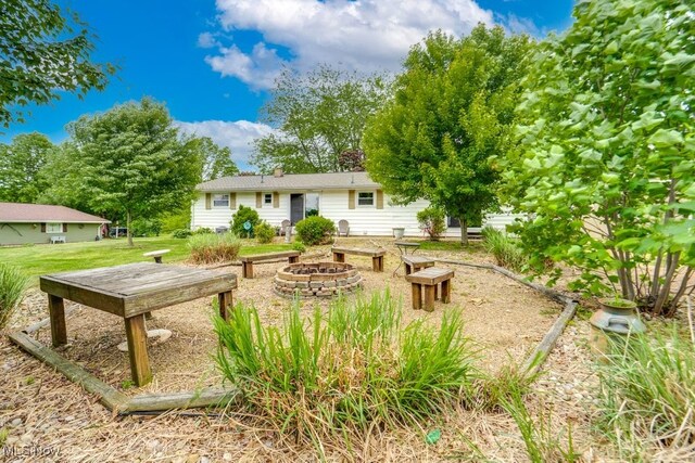 1260 Pleasant Ridge St SE, Minerva, OH 44657 - rear view of property with an outdoor fire pit and a lawn