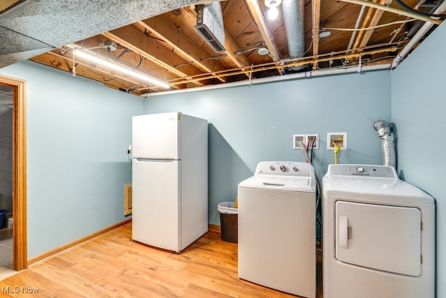 1260 Pleasant Ridge St SE, Minerva, OH 44657 - washroom with washer and clothes dryer and light wood-style floors