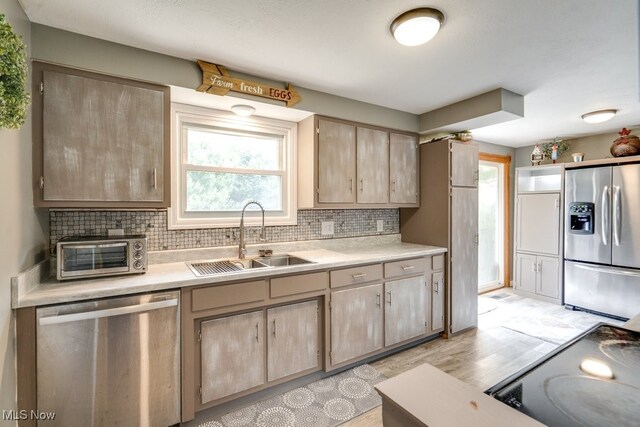 1260 Pleasant Ridge St SE, Minerva, OH 44657 - kitchen featuring stainless steel appliances, light brown cabinetry, light countertops, and healthy amount of natural light