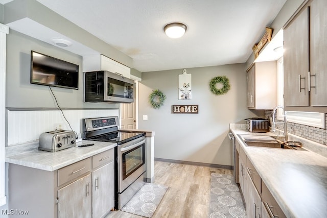 1260 Pleasant Ridge St SE, Minerva, OH 44657 - kitchen featuring appliances with stainless steel finishes, light countertops, tasteful backsplash, and light wood-type flooring