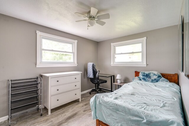 1260 Pleasant Ridge St SE, Minerva, OH 44657 - bedroom with light wood-type flooring and ceiling fan