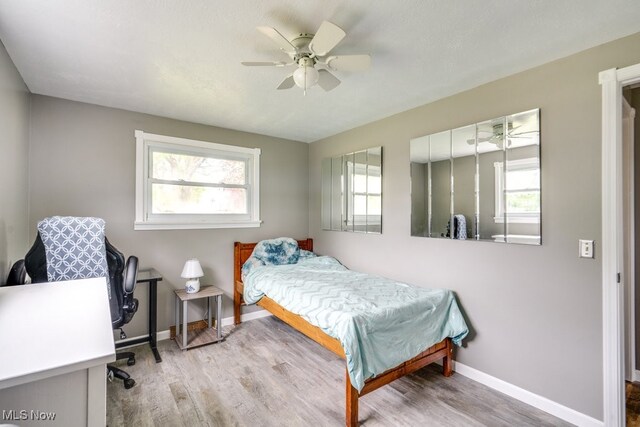 1260 Pleasant Ridge St SE, Minerva, OH 44657 - bedroom with multiple windows and wood finished floors