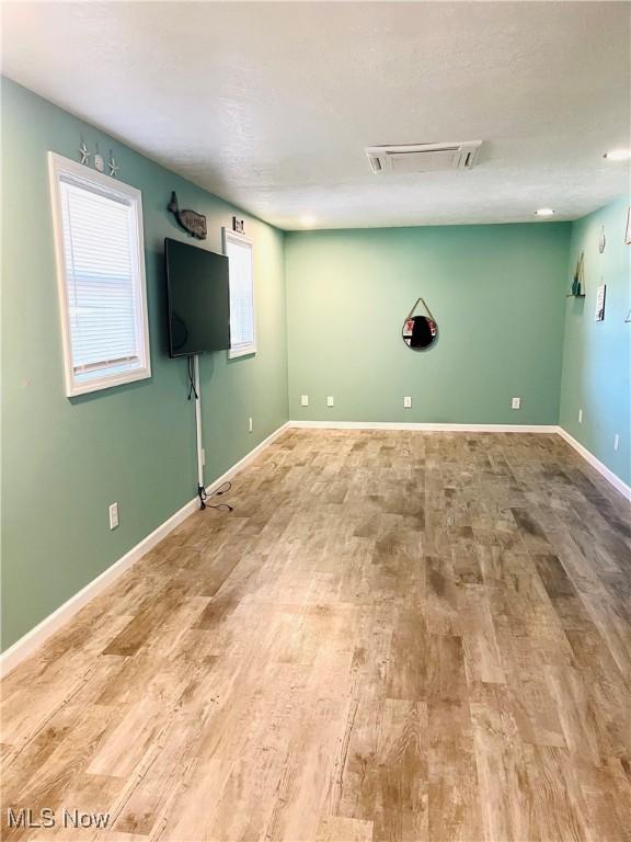 1260 Pleasant Ridge St SE, Minerva, OH 44657 - unfurnished living room featuring wood finished floors and baseboards