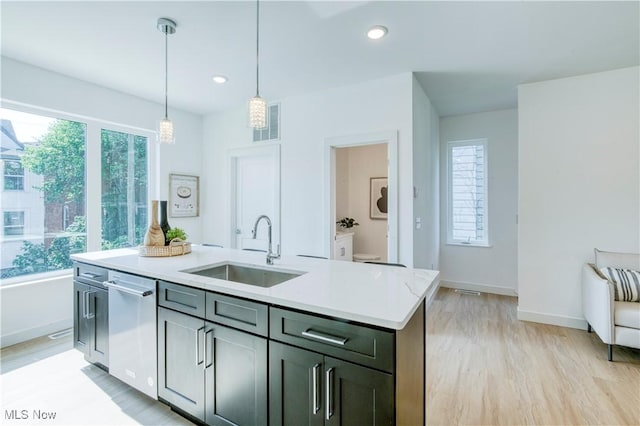 1369 W 74th St, Cleveland, OH 44102 - kitchen with stainless steel dishwasher, decorative light fixtures, light countertops, light wood finished floors, and recessed lighting