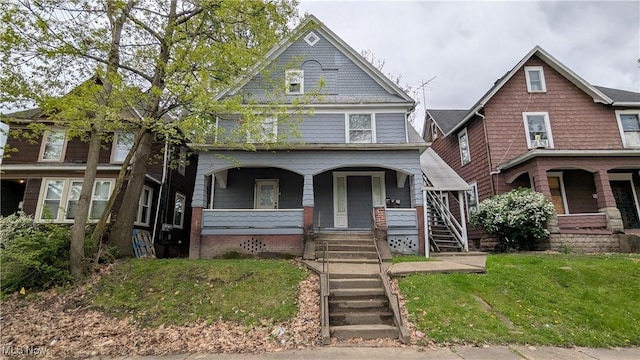 916 6th St NW, Canton, OH 44703 - view of front of property with covered porch, stairway, and a front yard