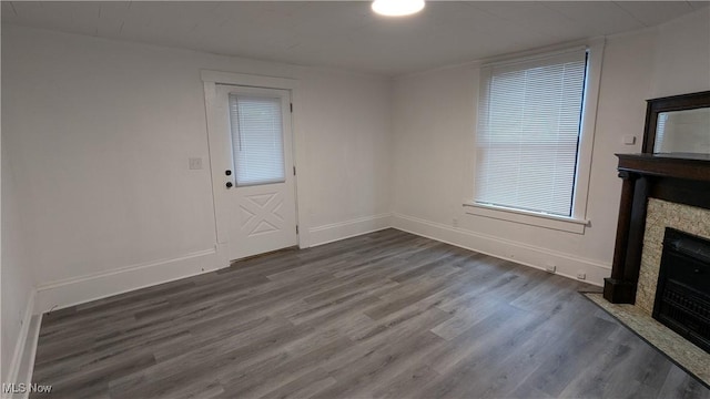 916 6th St NW, Canton, OH 44703 - unfurnished living room featuring wood finished floors and a fireplace with flush hearth